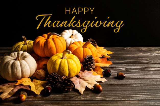 Photo happy thanksgiving day with pumpkin and nut on wooden table