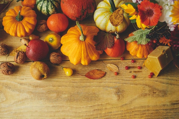 Happy Thanksgiving Pumpkins autumn berries leaves candle on wooden table rustic flat lay