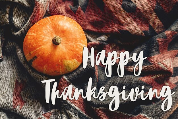 Photo happy thanksgiving text sign flat lay autumn pumpkin on stylish hipster fabric scarf space for text top view seasonal greetings fall holidays harvest time cozy mood