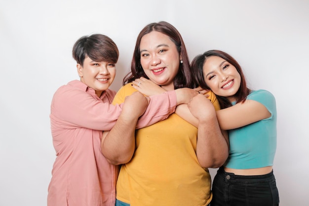 Happy three close friends hugging each other showing friendly gesture