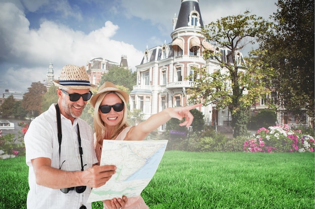 Happy tourist couple using map and pointing against sunny day by the river