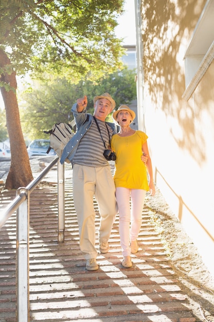 Happy tourist couple walking in the city 