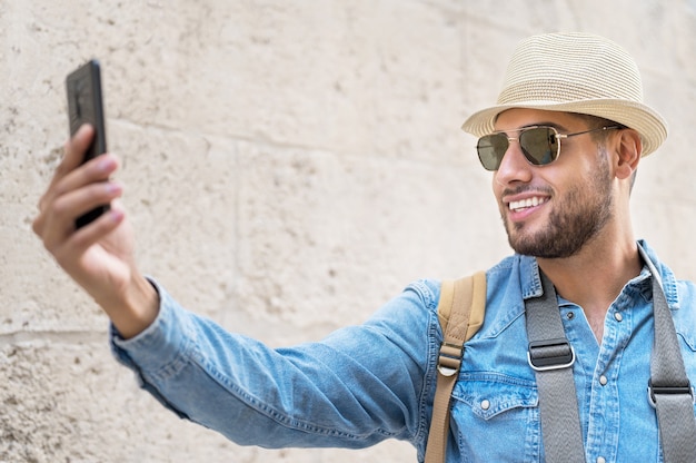 Happy tourist taking selfie in old city