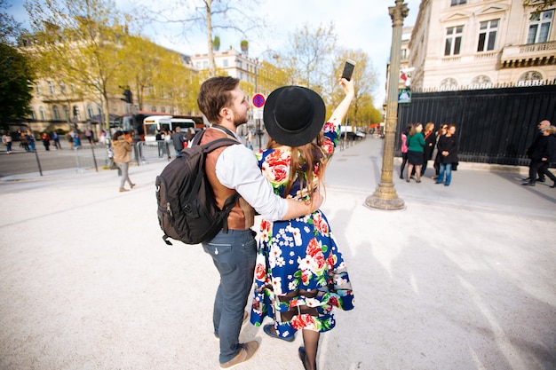 Happy tourists taking selfies in the city