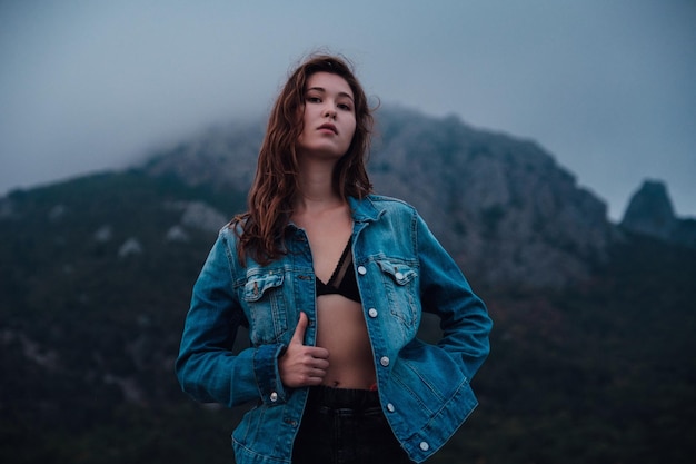 Happy traveler hipster asian girl on top of cloudy mountains