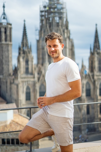 Happy traveler standing against old building in city