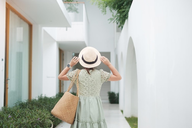 Happy traveler woman in white dress and hat enjoy in holiday time Southeast Asia travel trip and summer vacation concept