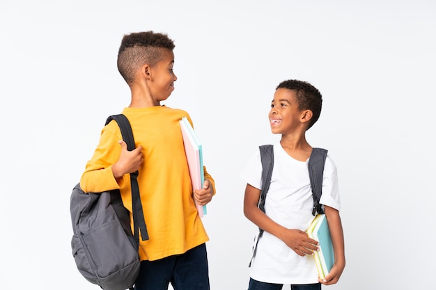 Happy Two boys African American students over isolated white 