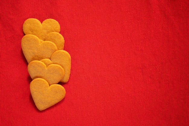 Happy valentine's day heart shaped gingerbread cookie on red background with copy space