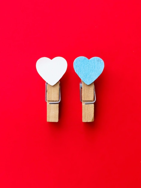 Photo happy valentines day 2021. two clothespin with hearts. postcard