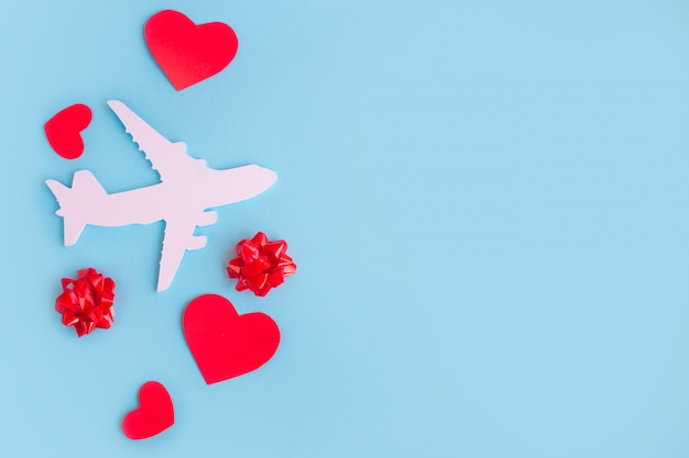 Happy valentines day. children's plane on a blue background with red heart