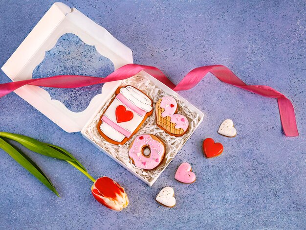 Happy Valentines day greeting card A gift box with sweet gingerbread in the form of a heart