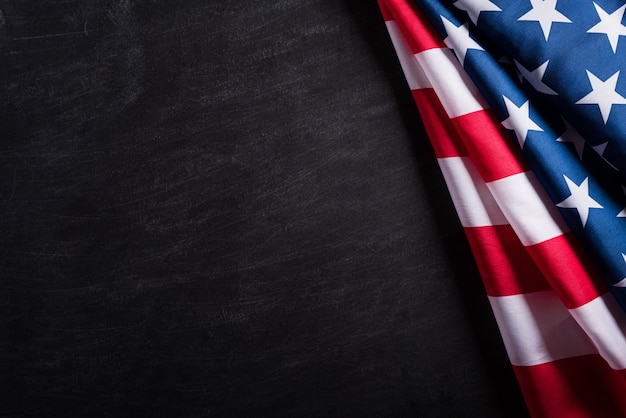 Happy Veterans Day. American flags against a blackboard background. 