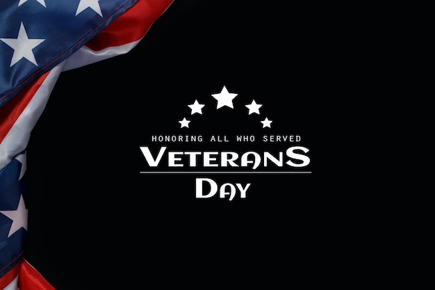 Happy Veterans Day. American flags with the text thank you veterans against a black background. November 11.