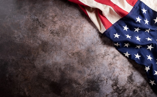 Happy Veterans Day concept. American flags against a dark stone  background. November 11.