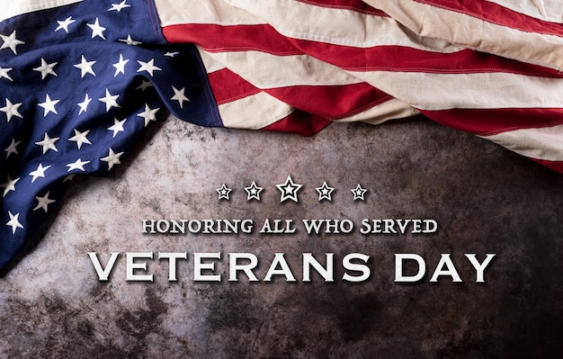 happy veterans day concept. american flags against a dark stone  background. november 11.