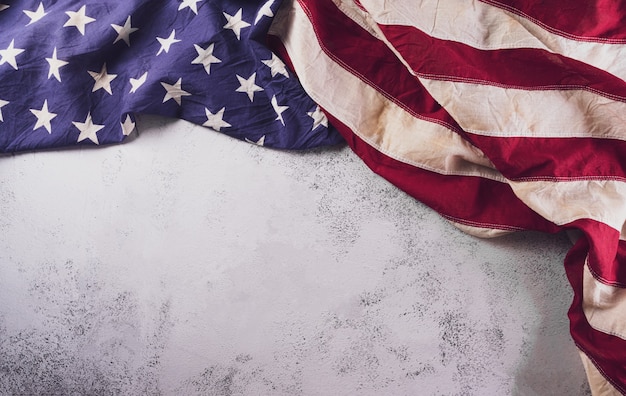 Happy Veterans Day concept. American flags against a white stone  background. November 11.