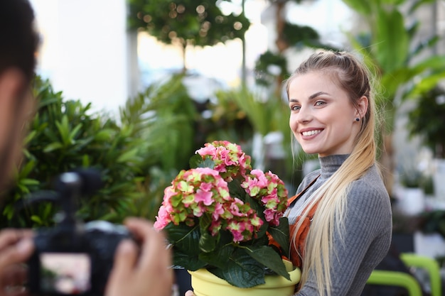 Happy Vlogger Posing with Flower to Camera Man