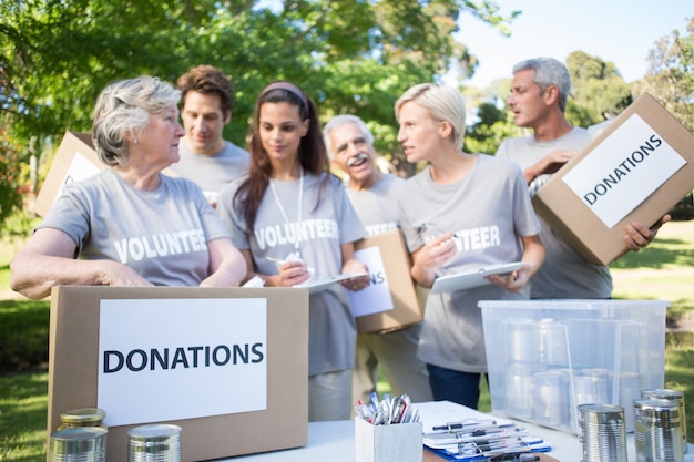 Happy volunteer family holding donation boxes 