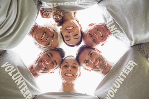 Happy volunteer family looking down at the camera