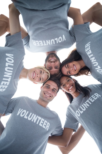 Photo happy volunteers forming huddle