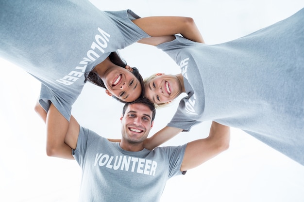 Happy volunteers forming huddle