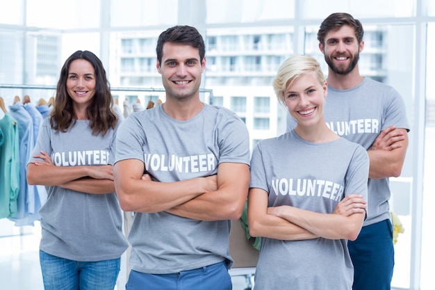 Happy volunteers friends smiling to the camera