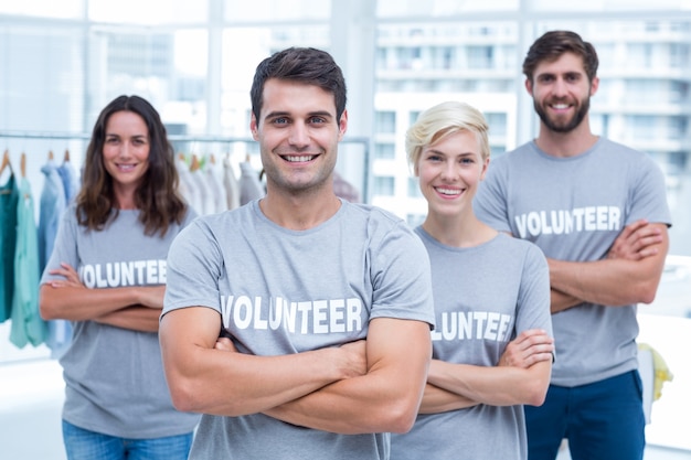 Happy volunteers friends smiling to the camera