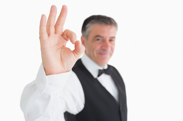 Happy waiter making OK sign