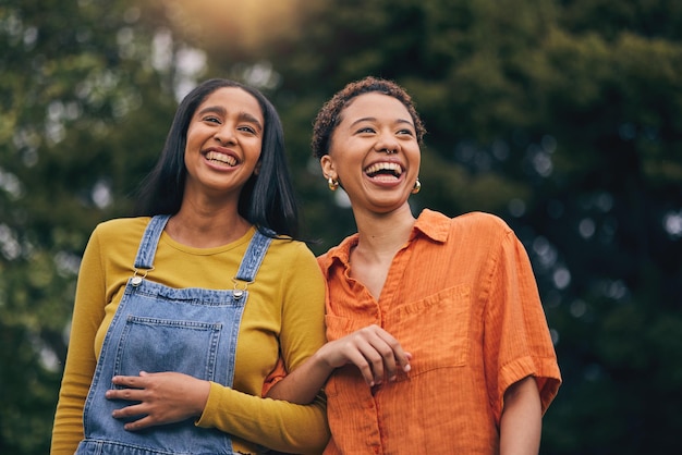 Happy walk and girl friends in park with laugh and funny joke with bonding and gossip outdoor Gen z young people and smile with female friendship freedom and holiday with joy on student vacation