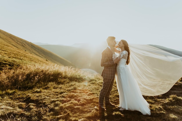 Happy wedding couple are walking in the mountains