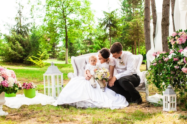 Happy wedding couple at the outdoor wedding decor