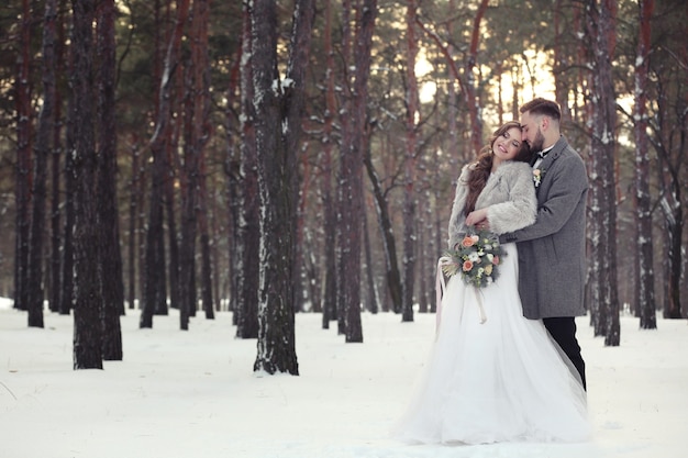 Happy wedding couple outdoors on winter day