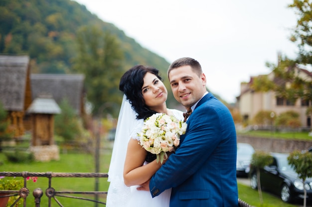 Happy wedding couple walking in the park