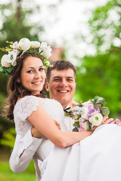 Happy wedding day groom holding the bride