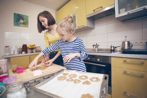 Happy weekend - Sister girls cook a Linzer Cookies in the kitchen