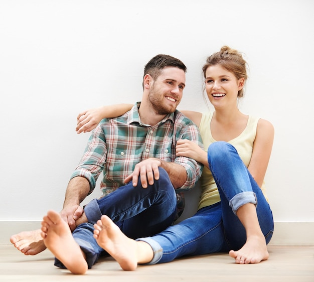 Happy whenever Im with you Shot of an affectionate young couple sitting beside each other on the floor at home