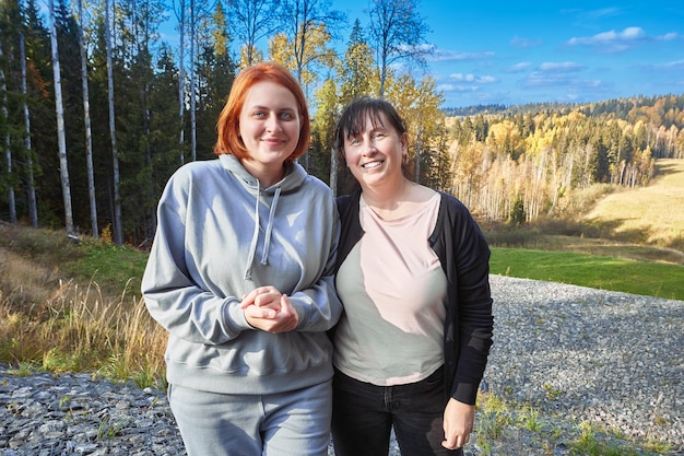 Happy white women stand in forest during walking