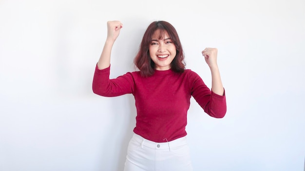 Happy and winner Asian beautiful girl with red shirt in white background