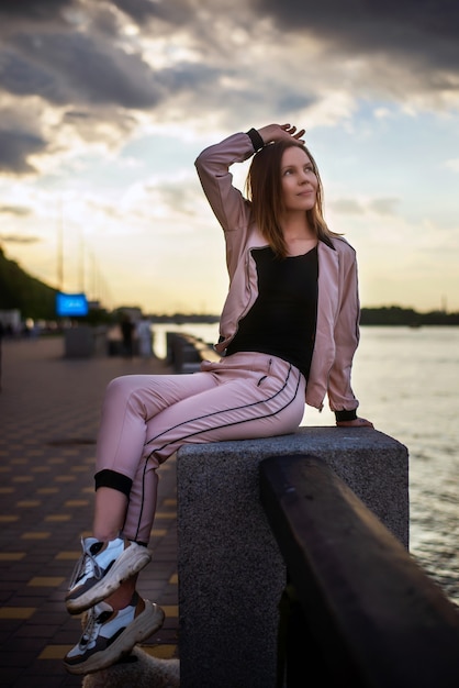 Happy woman 40 years old on the embankment of the river