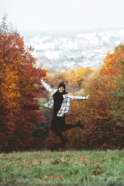 Happy woman autumn city park town on background copy space