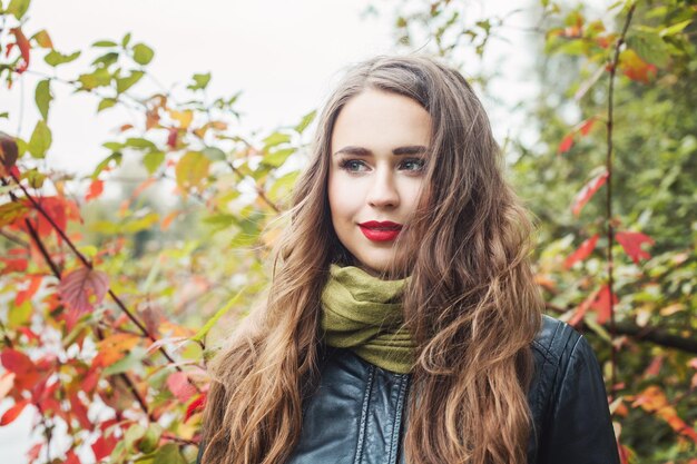 Happy woman in autumn park outdoor