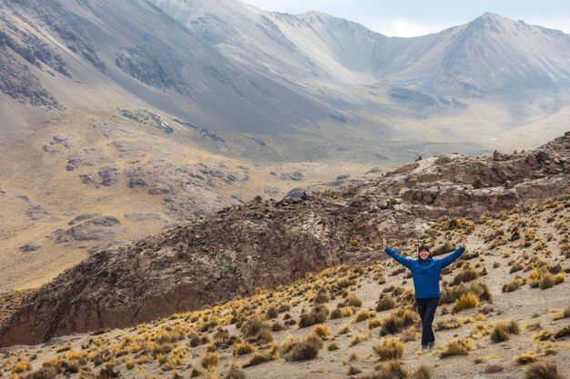 Happy woman on the background of mountains Altiplano Uyuni Bolivia