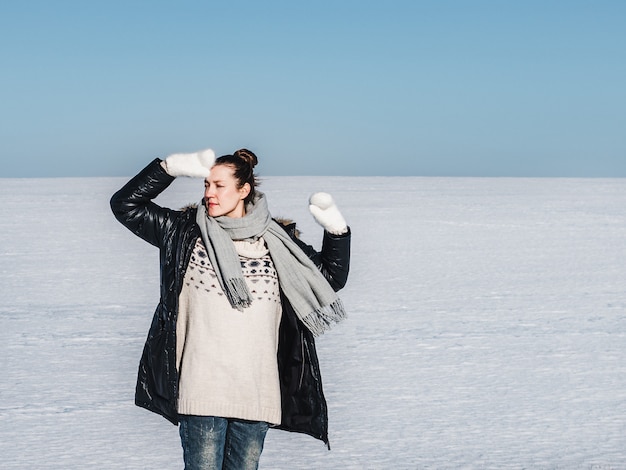 Happy woman on a background of a snowy field