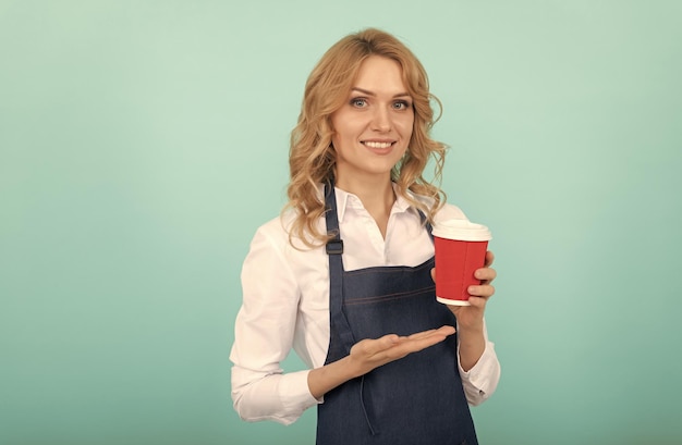 Happy woman barista in cook apron drink takeaway coffee barista