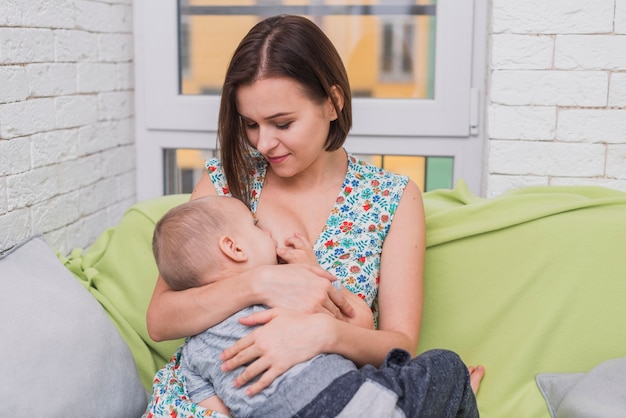 Photo happy woman breastfeeding her son