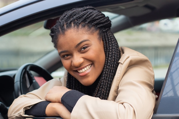 The Happy woman in a car driving, African American