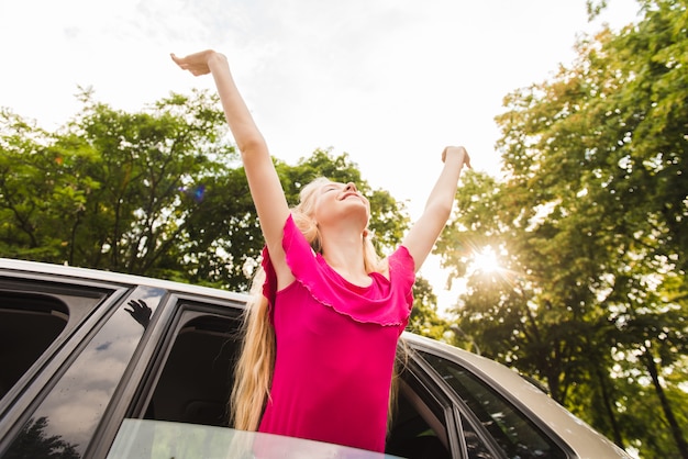 Happy woman in car window