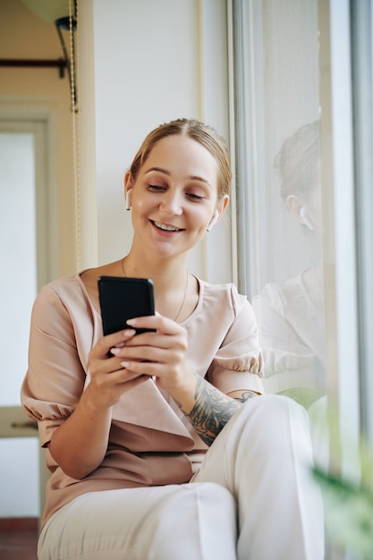 Happy Woman Choosing Playlist