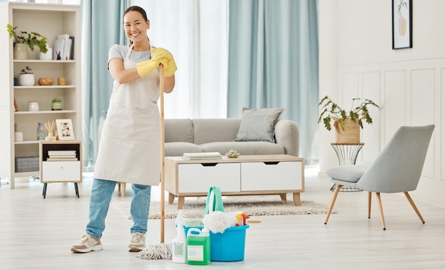 Photo happy woman cleaning home floor house work and smile in home service mopping living room job with gloves and happy to clean house apartment portrait of asian cleaner or housewife housekeeping